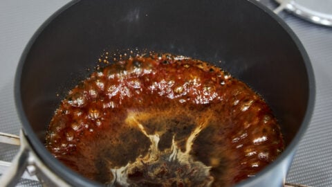 Boiling brown sugar to make the black syrup.