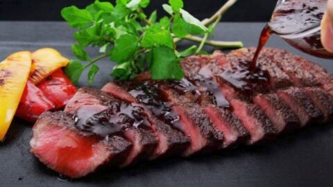 Sliced A5 Wagyu Steak drizzled with sauce.