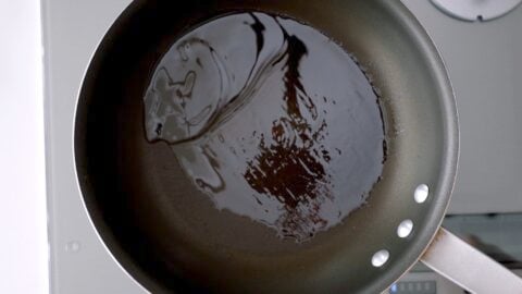 Hot oil in a non-stick frying pan.